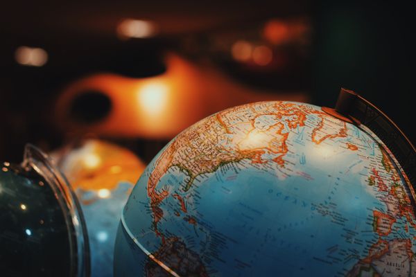 Globe sitting on a table in a dark room.