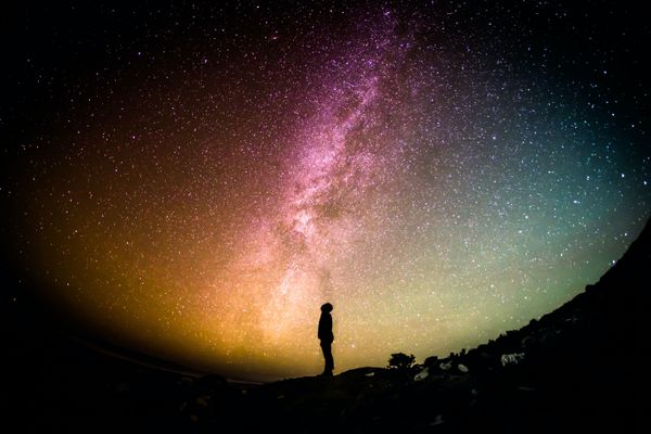 Silhouette starring up into the night sky.