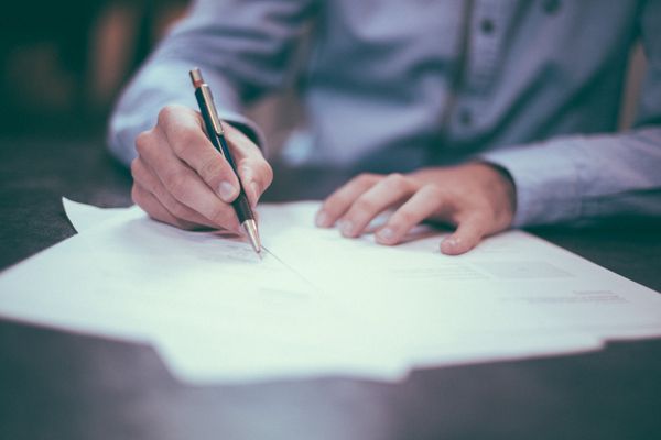 Person signing papers.