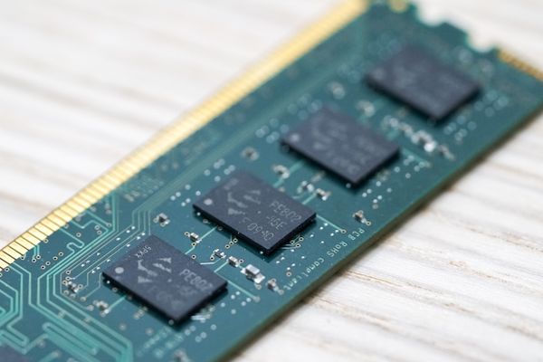 Stick of computer memory sitting on table.