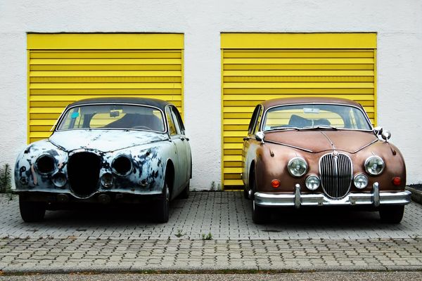 Two identical cars, but one in terrible condition, and the other in great condition.
