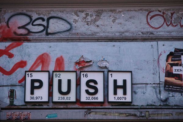 Wall with graffiti and letters PUSH.