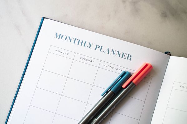 Open notebook calendar displaying a monthly planner page.