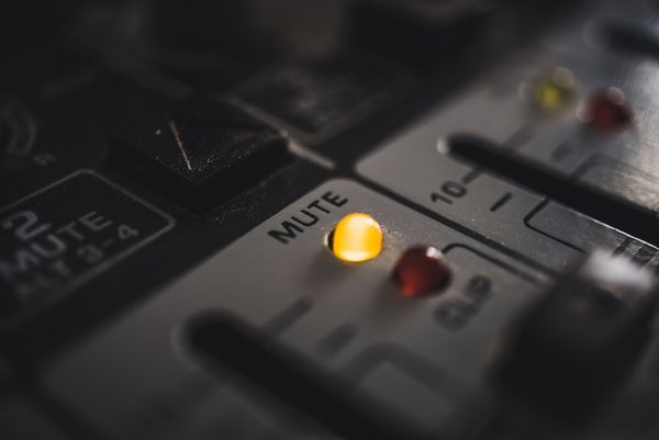 Switchboard used for musical production with the mute button lit up.